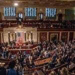 A crowded congressional chamber with members in discussion