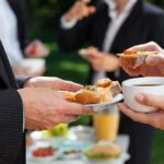 Professionals enjoying refreshments at an outdoor event