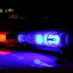 Close-up of police lights flashing in blue and red at night