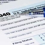 Close-up of a U.S. Individual Income Tax Return form 1040 with a pen