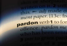 The word pardon highlighted in a dictionary.