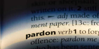 The word pardon highlighted in a dictionary.
