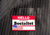 Hello my name is Socialist name tag on suit.