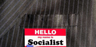 Hello my name is Socialist name tag on suit.