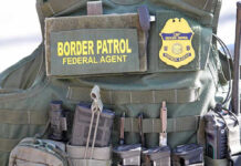 Protest Erupts Into CHAOS – Another ICE Agent ATTACKED! Border Patrol vest with gear and communication equipment.