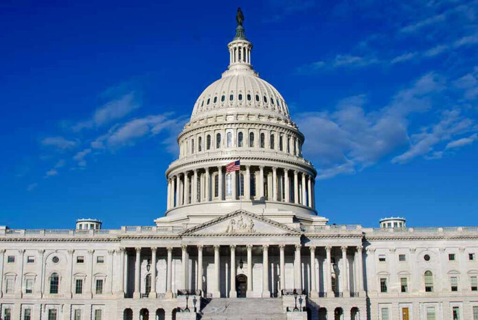 2406965967 US Capitol Building against blue sky.