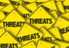 Yellow warning signs with the word THREATS.