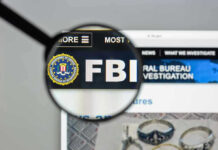 FBI website shown through magnifying glass.