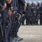 Line of police officers in uniform in formation.
