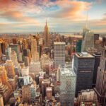 Mamdani Appoints Socialist Army Leader to Top Post Aerial view of New York City skyline during sunset with skyscrapers and clouds