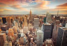Aerial view of New York City skyline during sunset with skyscrapers and clouds
