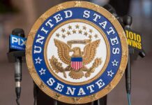 Warren SIDES With Trump – Demands Congressional Action! Official seal of the United States Senate with microphones in the background