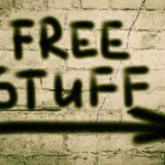 Graffiti on a brick wall stating FREE STUFF with an arrow