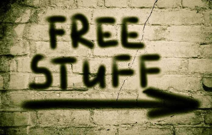 Graffiti on a brick wall stating FREE STUFF with an arrow