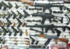 Christmas AR-15 Gift Sparks Murder Trial Wall display of various firearms in a store.