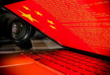 Laptop screen displaying Chinese flag and code.