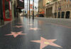 Hollywood Walk of Fame stars on sidewalk.