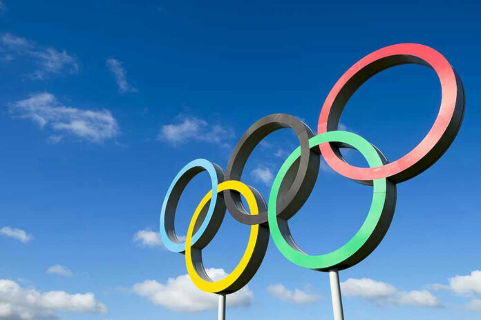 328832081 Olympic rings sculpture against blue sky.