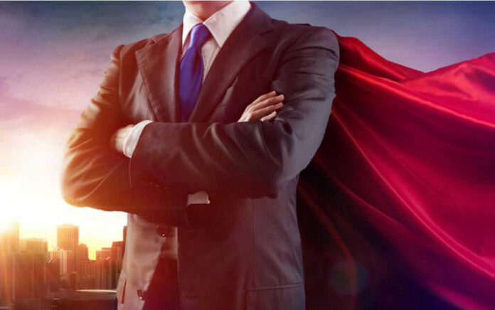 399664645 Businessman wearing a cape, standing confidently.