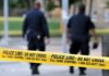 Drive-By Gunfire Rips Candidate’s Home Police officers walking past caution tape at a crime scene