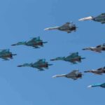 A formation of military jet fighters flying in a clear blue sky