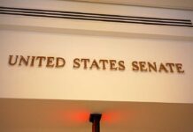 BRUTAL Senate Takedown: “You Disgust Me” Sign displaying United States Senate in a government building