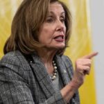 A female politician passionately speaking with her hand raised