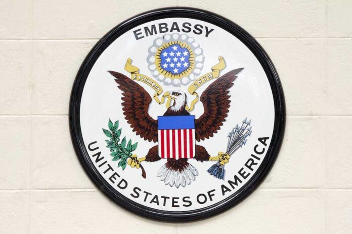 shutterstock_228233305.jpg Seal of the United States Embassy featuring an eagle and the American flag