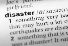 Close-up of a dictionary page showing the definition of the word 'disaster'