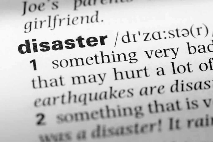 Close-up of a dictionary page showing the definition of the word 'disaster'