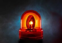 An illuminated orange emergency light on a dark background