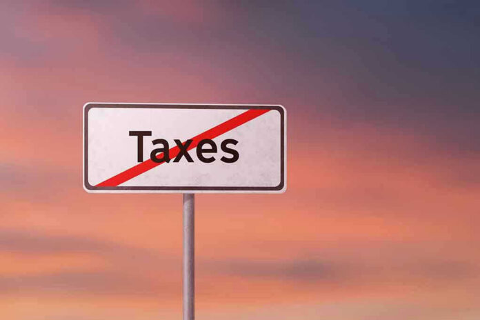 Sign with the word Taxes crossed out.