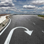 Curved road with a U-turn arrow marking.