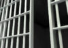 Close-up of prison cell bars.