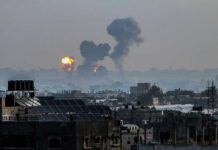U.S. Tanker HIT Inside Port Flames and smoke billowing over a cityscape.