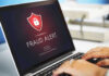 Laptop displaying fraud alert warning on screen
