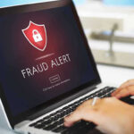 Laptop displaying fraud alert warning on screen