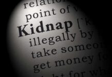 Close-up of a dictionary page showing the definition of the word kidnap