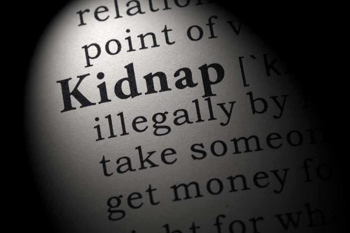 Close-up of a dictionary page showing the definition of the word kidnap