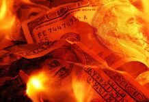 Taxpayers Stunned: $81K Per Homeless, No Results! Burning U.S. dollar bills surrounded by flames