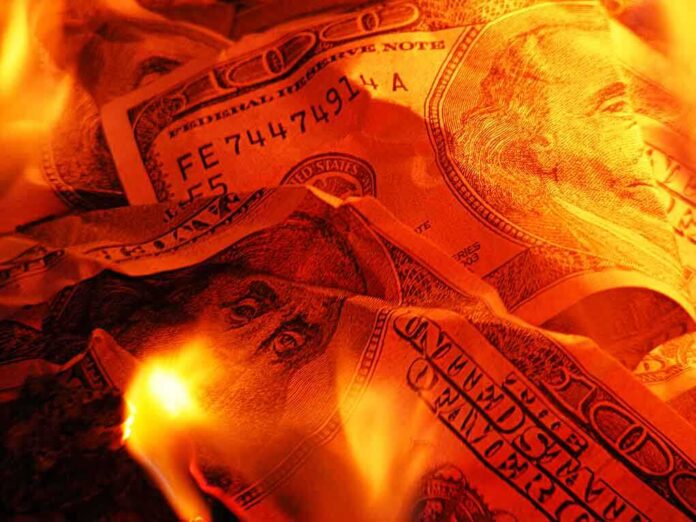 Burning U.S. dollar bills surrounded by flames