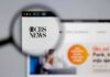 Magnifying glass focusing on CBS News logo on a website
