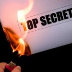NEW Abrams Tank’s SECRET POWER – Game-Changer! A hand holding a lighter igniting a paper labeled TOP SECRET as it catches fire