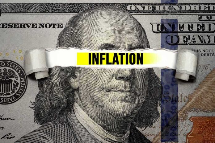 A hundred dollar bill with the word INFLATION prominently displayed across it