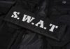 Beachfront Murder Sparks SWAT Siege Close-up of a SWAT uniform patch on black tactical gear