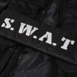 Close-up of a SWAT uniform patch on black tactical gear
