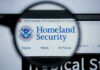 Magnifying glass showing Homeland Security website.