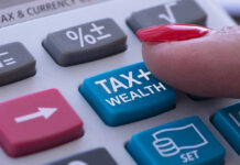 Finger pressing calculator tax and wealth button