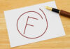 Fail grade written on paper with a pen.