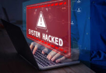 Warning sign System Hacked on laptop screen.